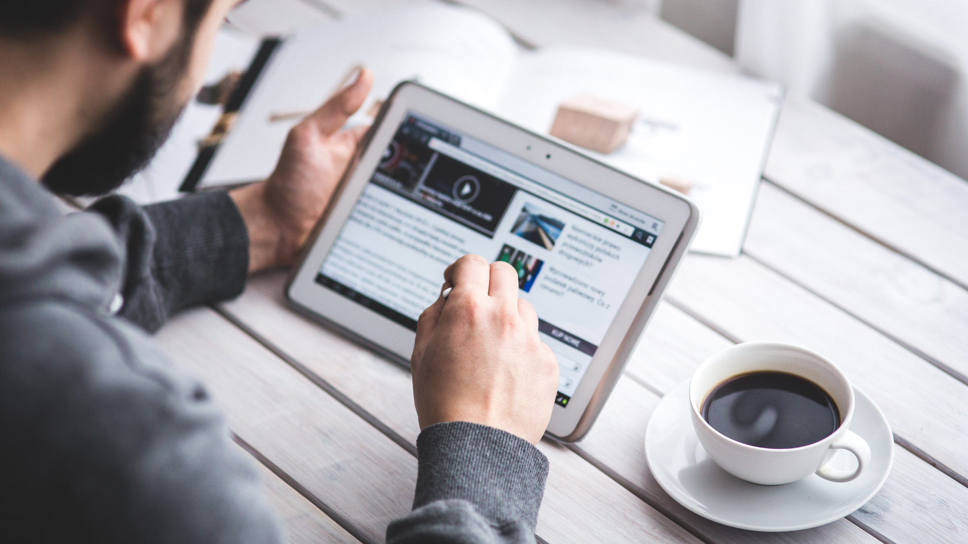 Image of a person looking carefully at some ads on his tablet