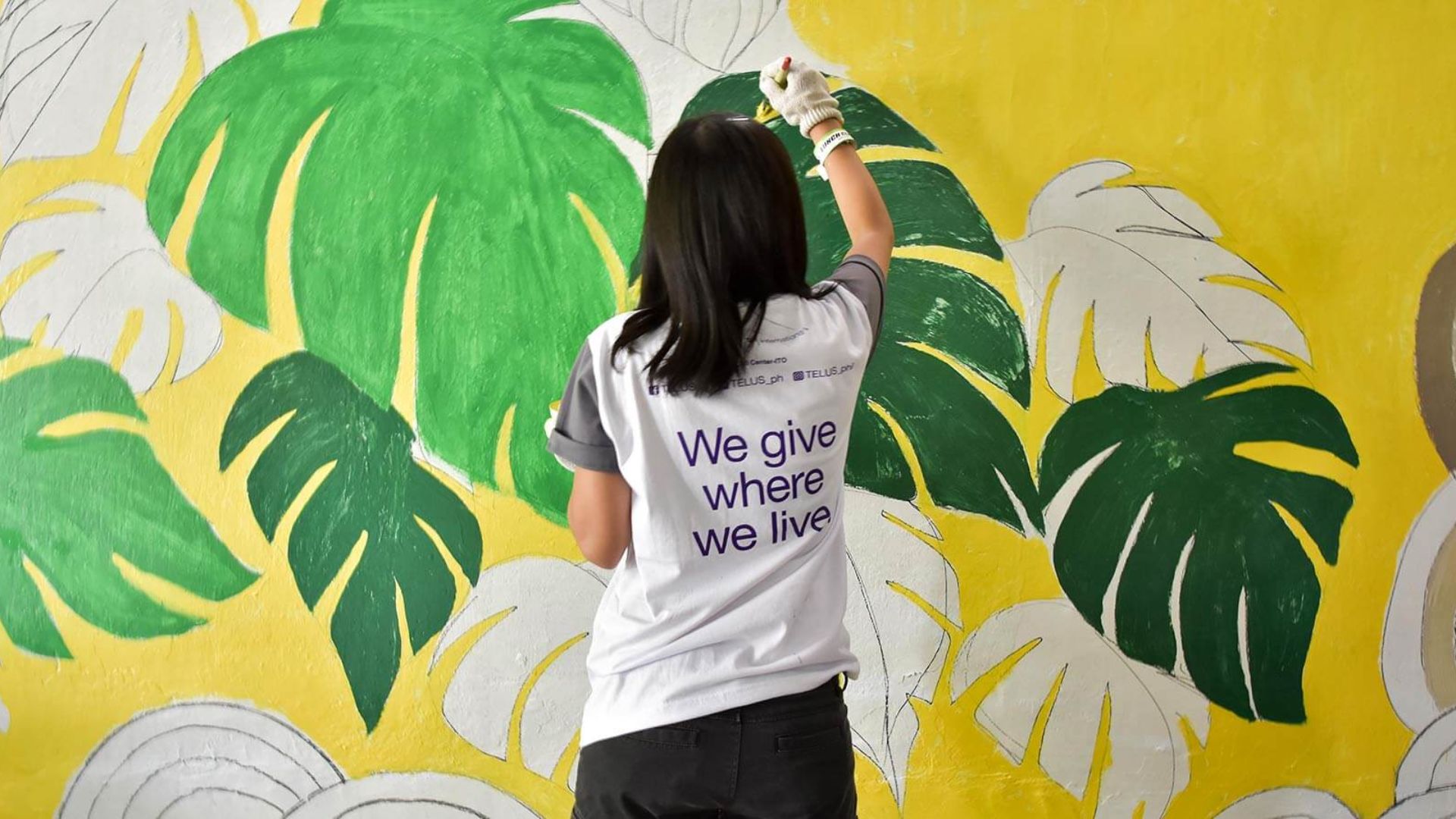 A girl painting on a wall